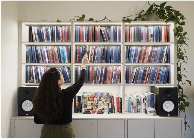 A bookshelf of yearbooks in the Yearbook Machine office